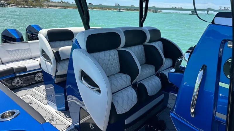 Slide: The Image of 2020 Nor-Tech 390 Sport boat interior with luxurious seating and ocean view. - 22