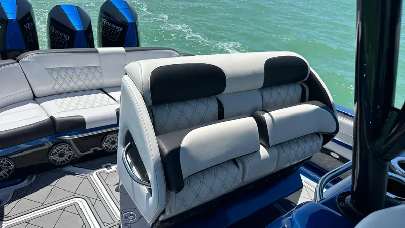 Slide: The Image of 2020 Nor-Tech 390 Sport boat interior with luxurious seating and ocean backdrop. - 24