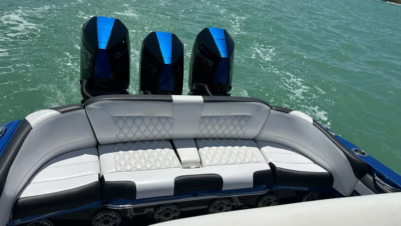 Slide: The Image of 2020 Nor-Tech 390 Sport boat with triple engines and luxurious seating on the water. - 25