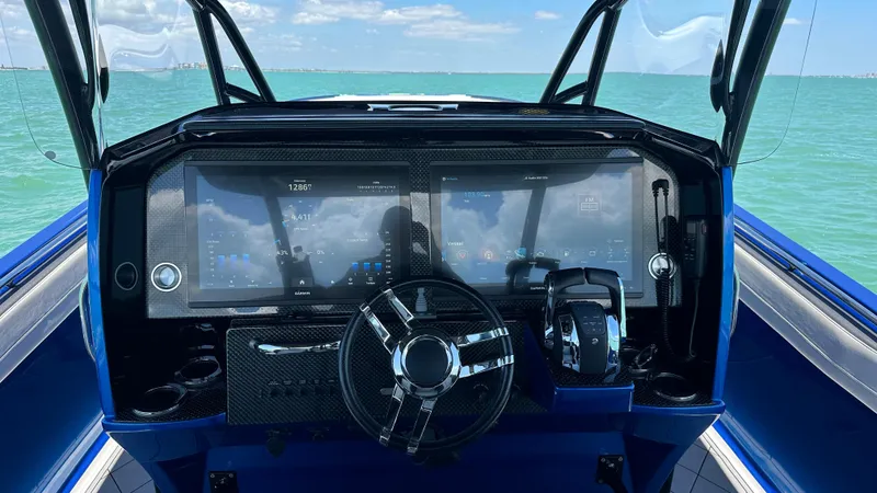 Slide: The Image of 2020 Nor-Tech 390 Sport dashboard with advanced navigation system on open water. - 30