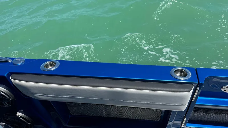 Slide: The Image of 2020 Nor-Tech 390 Sport boat, blue interior detail, overlooking green ocean water. - 34