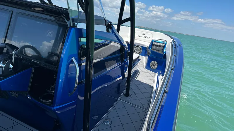 Slide: The Image of 2020 Nor-Tech 390 Sport boat on turquoise water under a clear blue sky. - 36