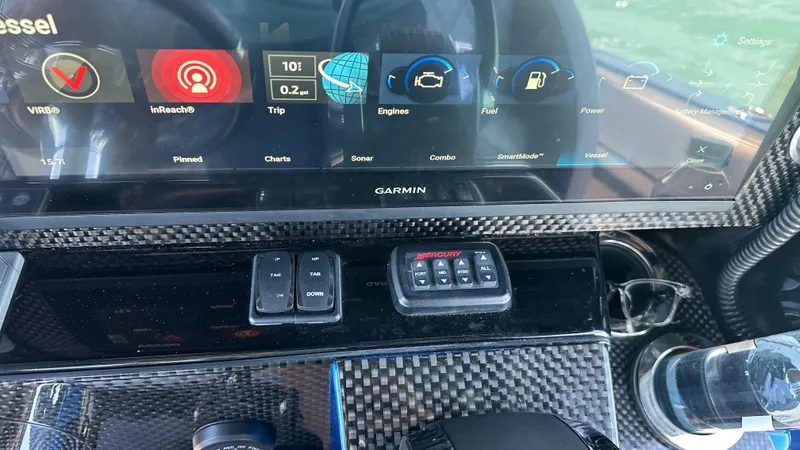 Slide: The Image of Dashboard of 2020 Nor-Tech 390 Sport with Garmin display and carbon fiber finish. - 37