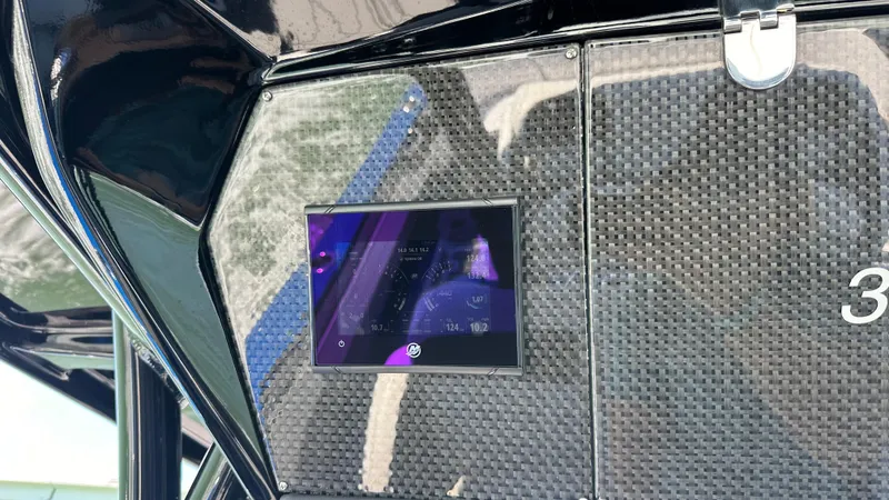 Slide: The Image of 2020 Nor-Tech 390 Sport dashboard with digital display and carbon fiber finish. - 43