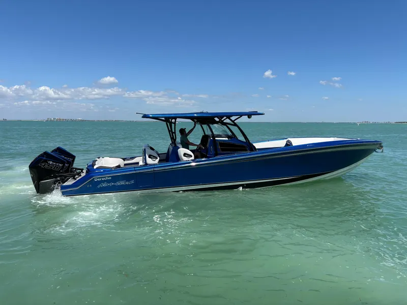 Slide: The Image of 2020 Nor-Tech 390 Sport boat cruising on clear blue water under a sunny sky. - 5