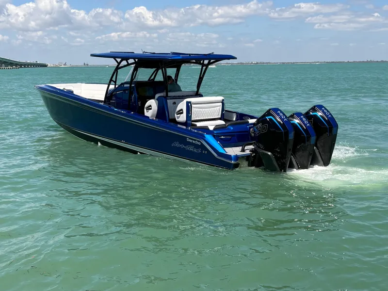 Slide: The Image of 2020 Nor-Tech 390 Sport boat cruising on clear blue water under a sunny sky. - 7