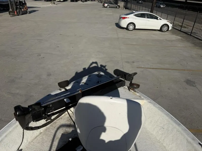 Slide: The Image of 1997 Polar 17 CC boat parked in a lot with a white car nearby. - 9