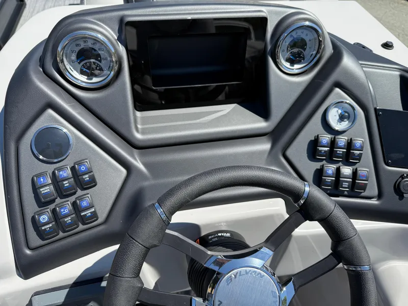 Slide: The Image of Steering console of 2025 Sylvan L-3 CLZ boat with modern controls and gauges. - 11