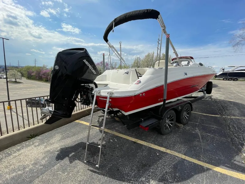 Slide: The Image of 2023 Stingray 212 SC boat interior with steering wheel and seating area. - 10
