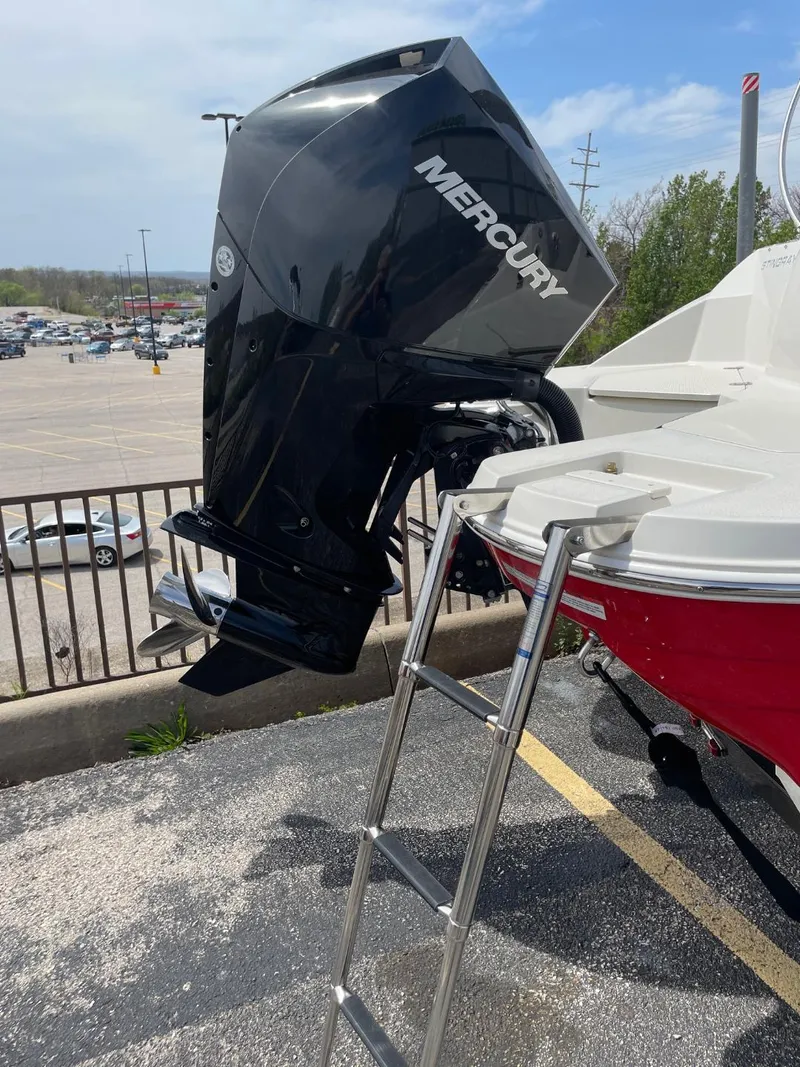 Slide: The Image of 2023 Stingray 212 SC boat dashboard with audio controls and cup holders. - 11