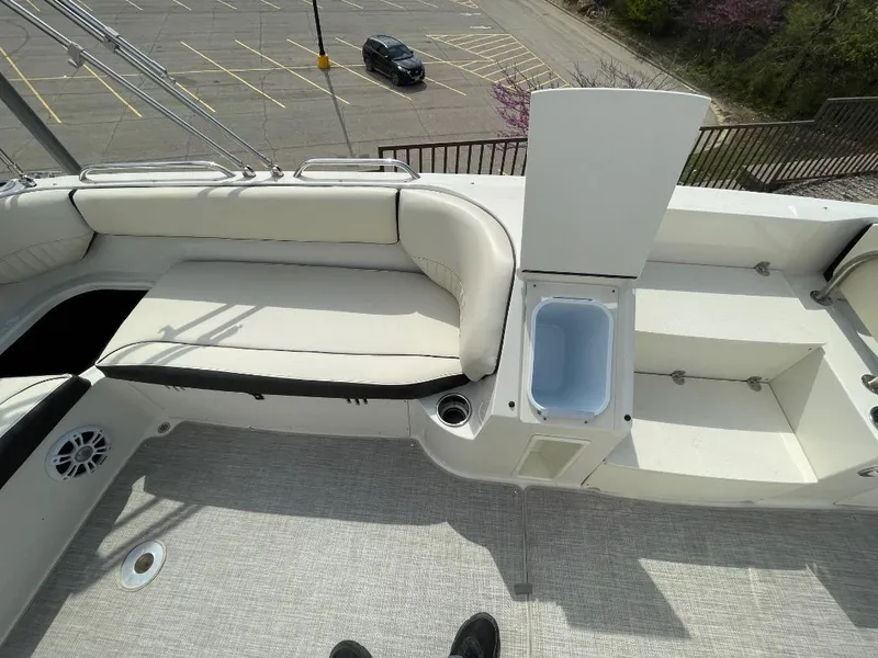Slide: The Image of 2023 Stingray 212 SC boat interior with seating and storage compartment. - 16