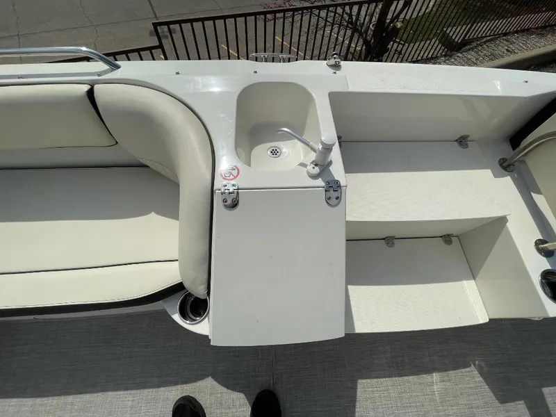 Slide: The Image of 2023 Stingray 212 SC boat interior with seating and speakers, showcasing modern design. - 17