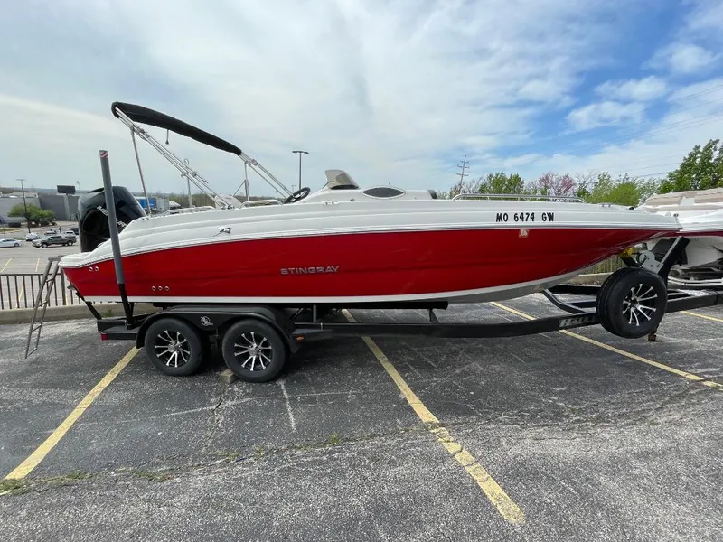 Slide: The Image of 2023 Stingray 212 SC boat interior with seating and cup holders. - 8