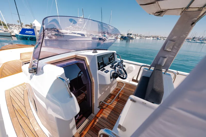 Slide: The Image of 2018 Fjord 36 Xpress boat interior with steering wheel, docked in marina. - 15