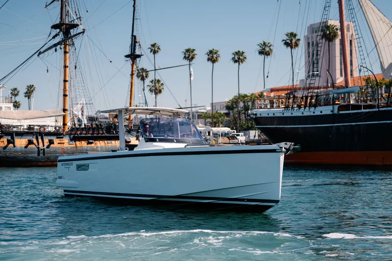 Slide: The Image of 2018 Fjord 36 Xpress boat cruising near historic ships and palm trees. - 21