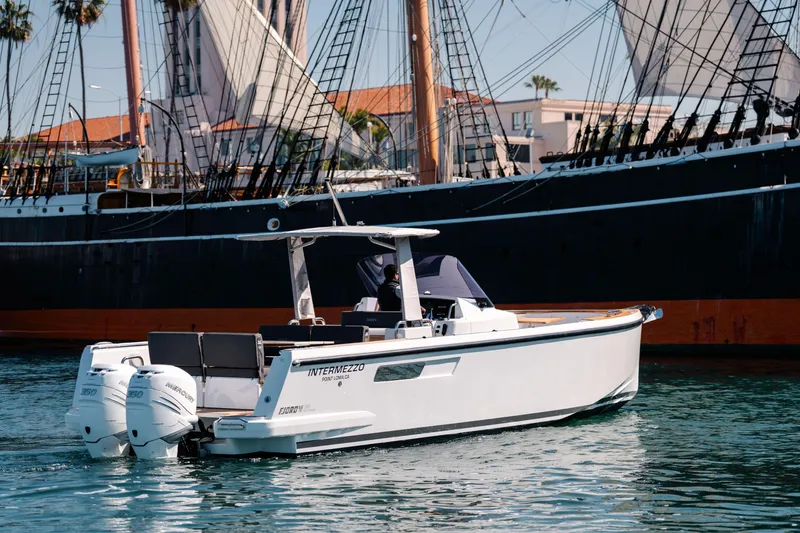 Slide: The Image of 2018 Fjord 36 Xpress boat on water near a large sailing ship. - 22