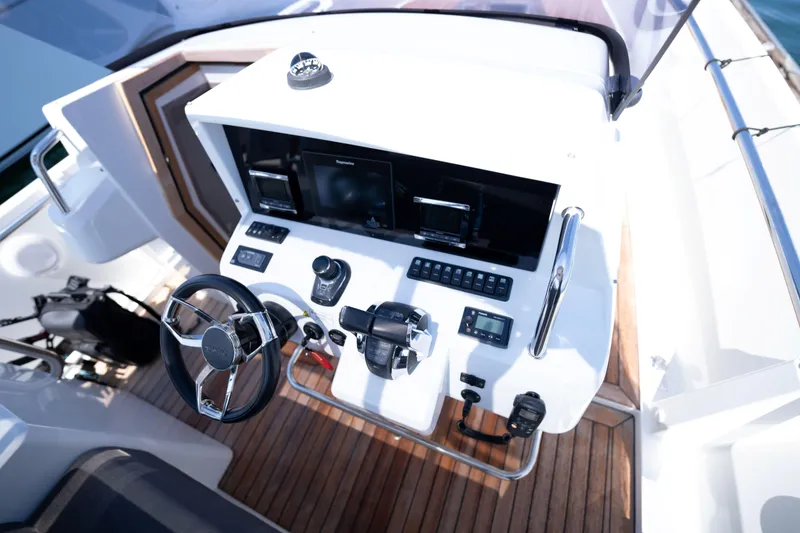 Slide: The Image of Cockpit of 2018 Fjord 36 Xpress yacht with modern controls and wooden flooring. - 24