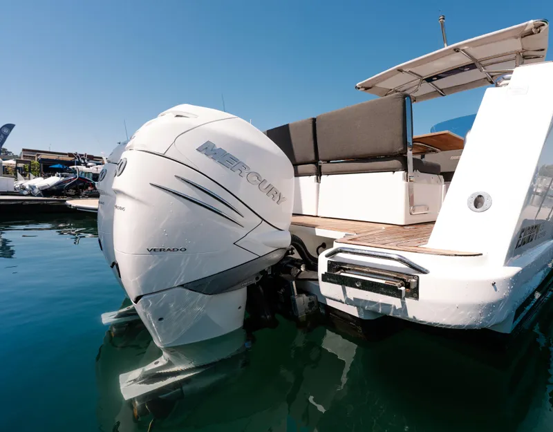 Slide: The Image of 2018 Fjord 36 Xpress boat with Mercury Verado engine, docked on calm water. - 25