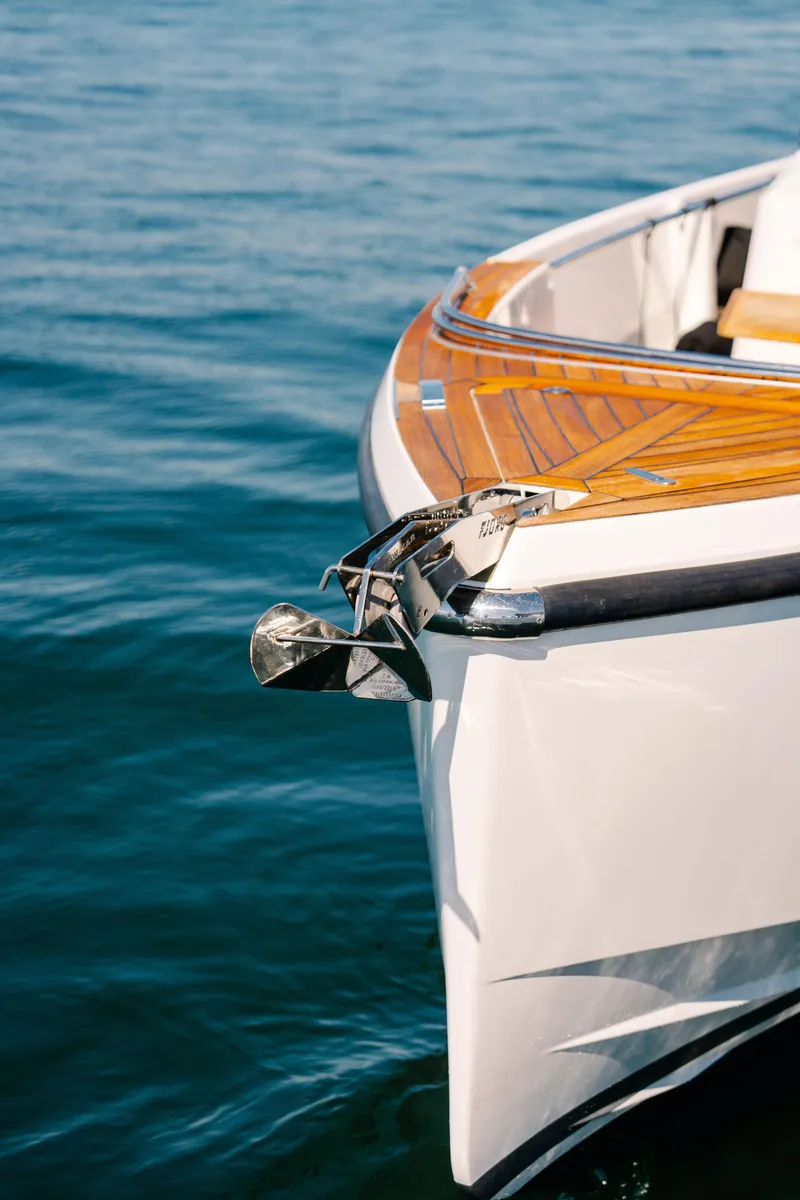 Slide: The Image of 2018 Fjord 36 Xpress boat with wooden deck on calm water. - 29