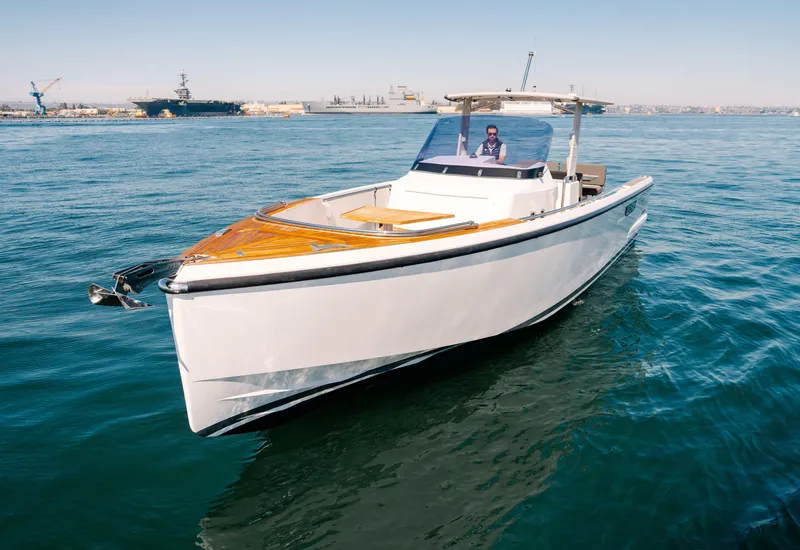 Slide: The Image of 2018 Fjord 36 Xpress boat cruising on open water, featuring sleek design and wooden deck. - 30