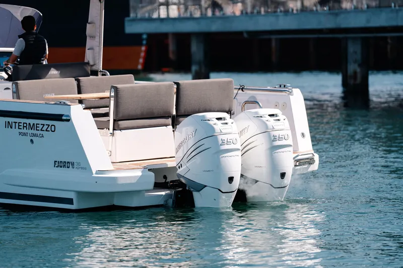 Slide: The Image of 2018 Fjord 36 Xpress boat with twin outboard engines on calm water. - 5