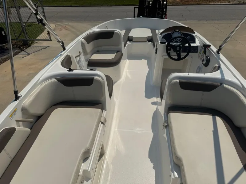 Slide: The Image of 2021 Bayliner Element E18 boat interior with seating and steering wheel. - 4