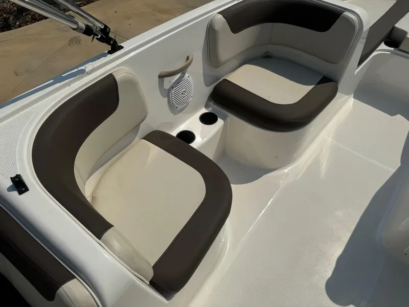 Slide: The Image of 2021 Bayliner Element E18 boat interior with cushioned seating and cup holders. - 6