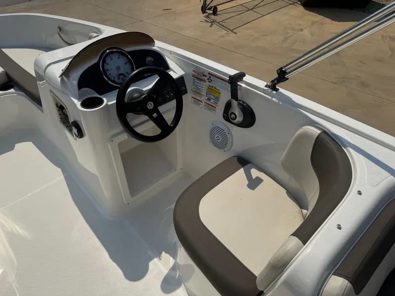 Slide: The Image of 2021 Bayliner Element E18 boat interior with steering wheel and seating. - 7
