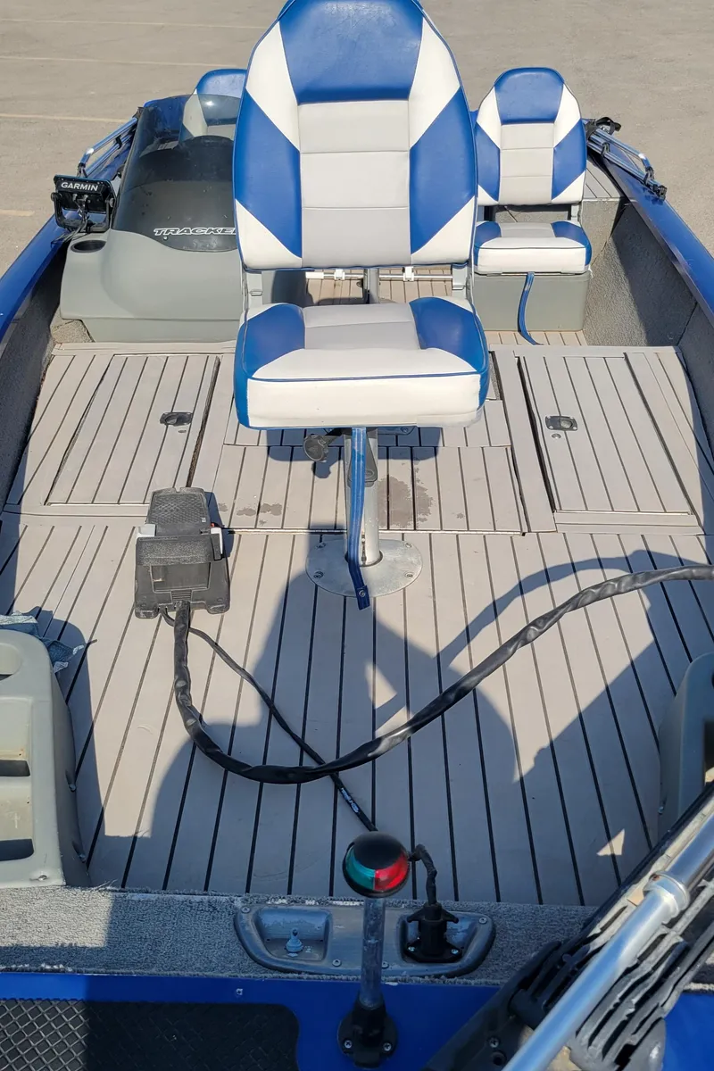 Slide: The Image of 2011 Tracker Pro Team 175TF boat with blue and white seating on deck. - 2