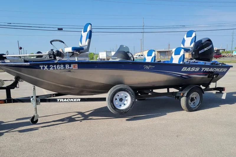Slide: The Image of 2011 Tracker Pro Team 175TF bass boat on trailer, featuring blue and white seating. - 4