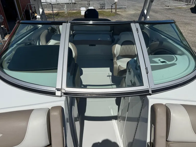 Slide: The Image of 2022 Crownline Eclipse E235 XS boat interior with seating and windshield. - 10