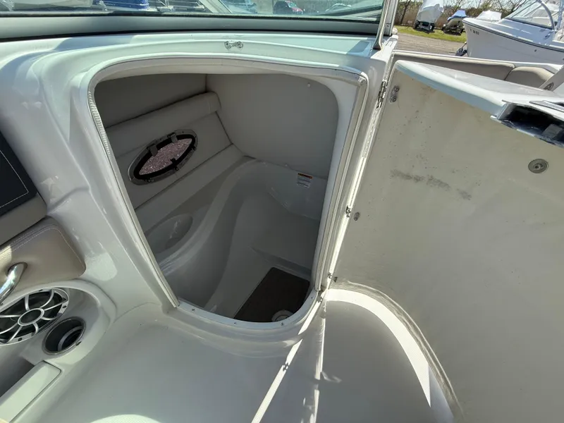 Slide: The Image of 2022 Crownline Eclipse E235 XS boat interior with open storage compartment. - 14