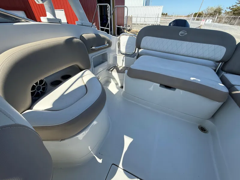 Slide: The Image of 2022 Crownline Eclipse E235 XS boat interior with beige and white seating. - 16