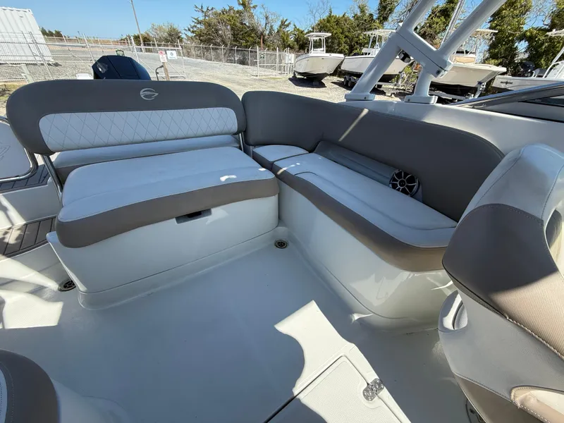 Slide: The Image of 2022 Crownline Eclipse E235 XS boat interior with cushioned seating and modern design. - 17