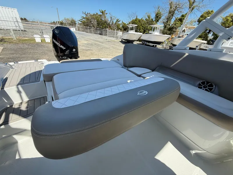 Slide: The Image of 2022 Crownline Eclipse E235 XS boat interior with cushioned seating and Mercury outboard motor. - 20