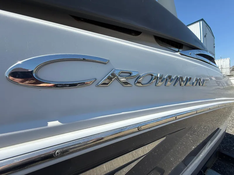 Slide: The Image of 2022 Crownline Eclipse E235 XS boat with chrome logo detail. - 23