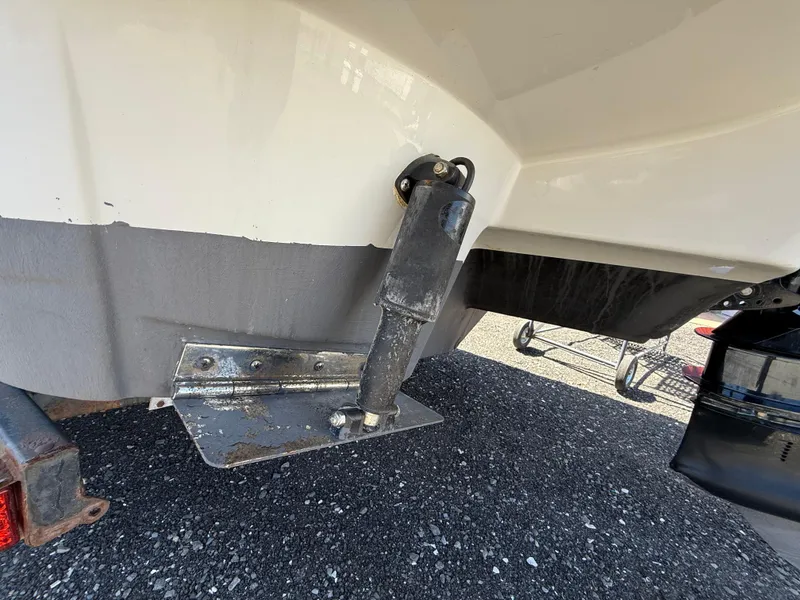 Slide: The Image of 2022 Crownline Eclipse E235 XS boat trim tab and actuator detail. - 9