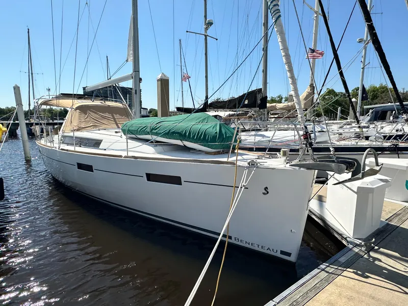 Slide: The Image of 2012 Beneteau Oceanis 41 sailboat docked at marina under clear blue sky. - 0