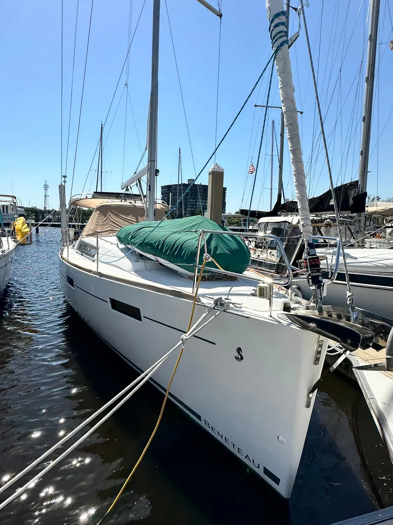 Slide: The Image of 2012 Beneteau Oceanis 41 sailboat docked in marina under clear blue sky. - 1