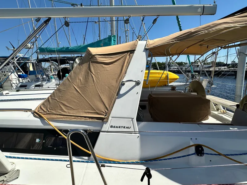 Slide: The Image of Beneteau Oceanis 41 sailboat, 2012 model, docked with tan covers and visible rigging. - 10