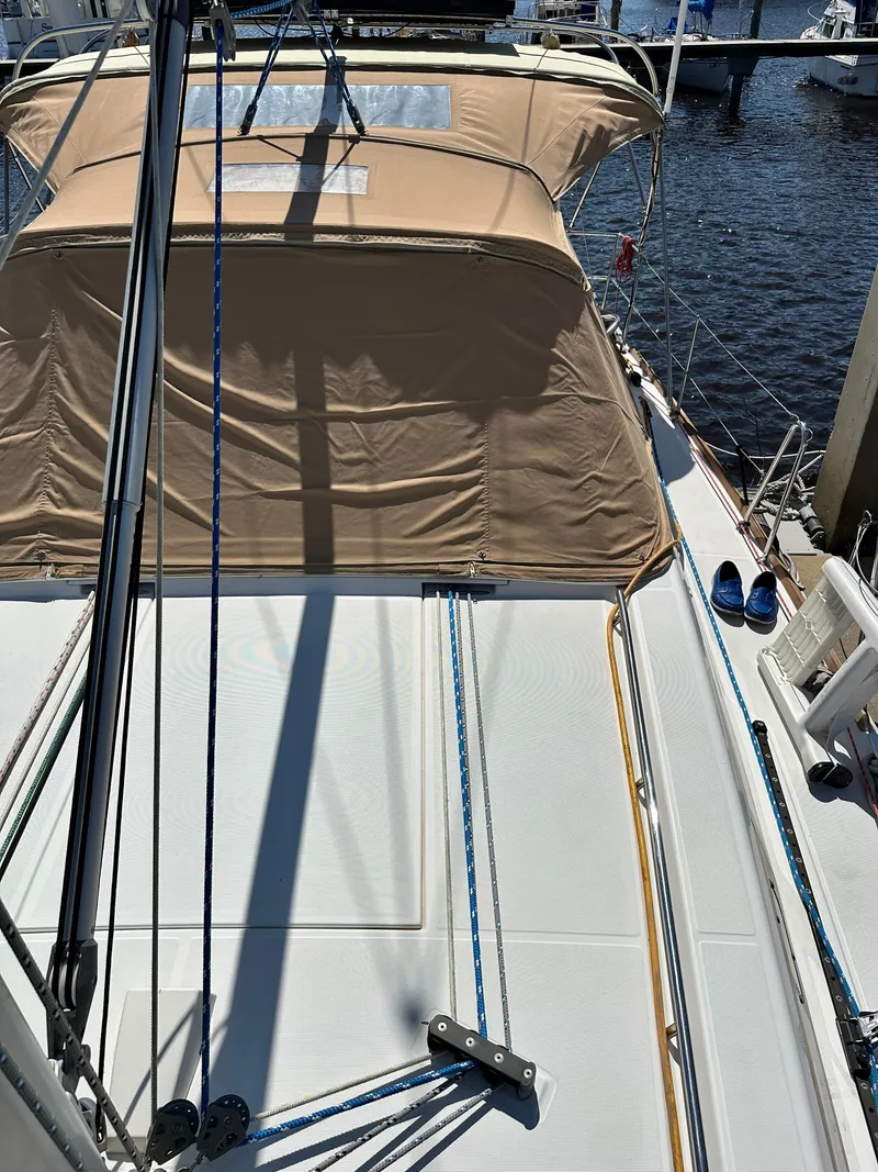 Slide: The Image of Beneteau Oceanis 41 sailboat deck, 2012 model, with beige canopy and marina view. - 15