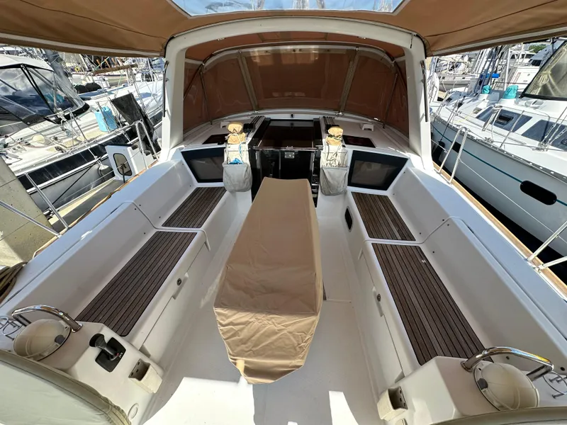 Slide: The Image of Spacious cockpit of 2012 Beneteau Oceanis 41 sailboat with teak seating and covered table. - 19