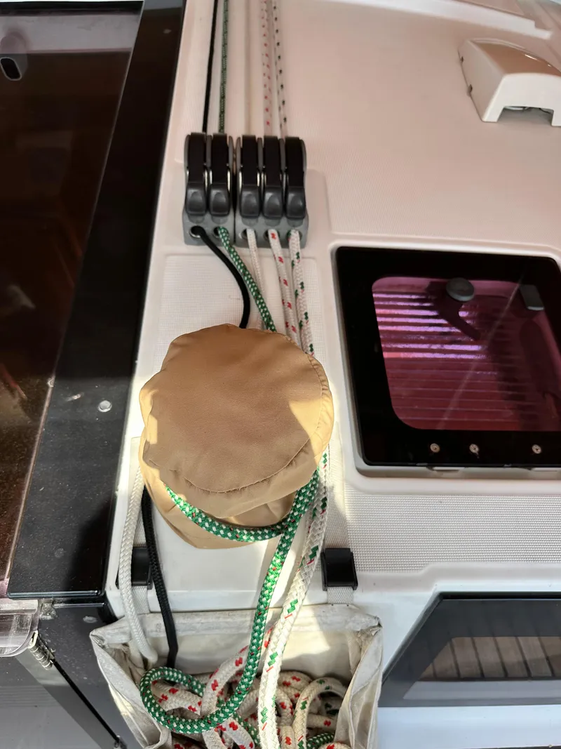 Slide: The Image of Deck of 2012 Beneteau Oceanis 41 with ropes and winch cover. - 24