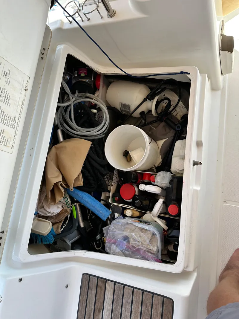 Slide: The Image of Storage compartment on a 2012 Beneteau Oceanis 41 sailboat, filled with various boating supplies. - 27