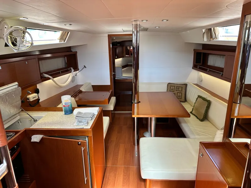 Slide: The Image of Interior of 2012 Beneteau Oceanis 41 yacht with modern wood and white furnishings. - 30