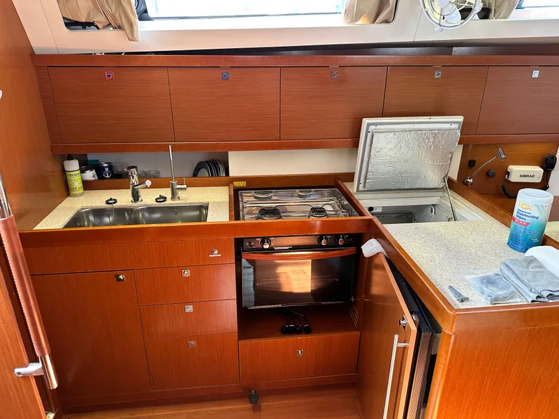 Slide: The Image of Modern kitchen in 2012 Beneteau Oceanis 41 yacht with wood cabinetry and appliances. - 32