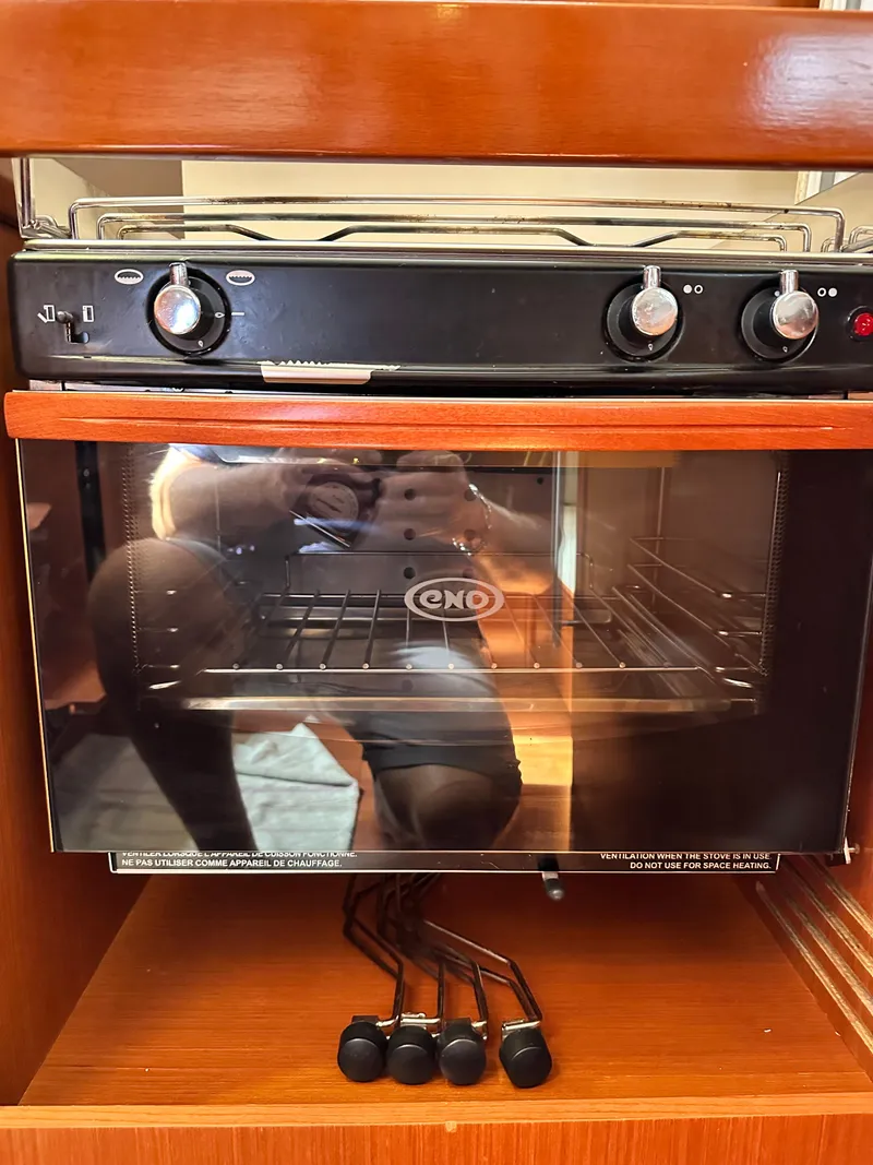 Slide: The Image of Built-in oven on 2012 Beneteau Oceanis 41 yacht, featuring black knobs and glass door. - 37