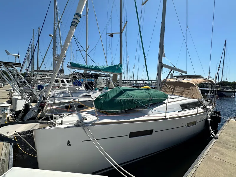 Slide: The Image of 2012 Beneteau Oceanis 41 sailboat docked at marina under clear blue sky. - 4