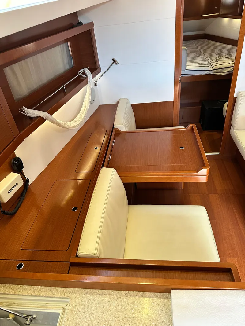 Slide: The Image of Interior of 2012 Beneteau Oceanis 41 yacht with wooden table and seating area. - 49