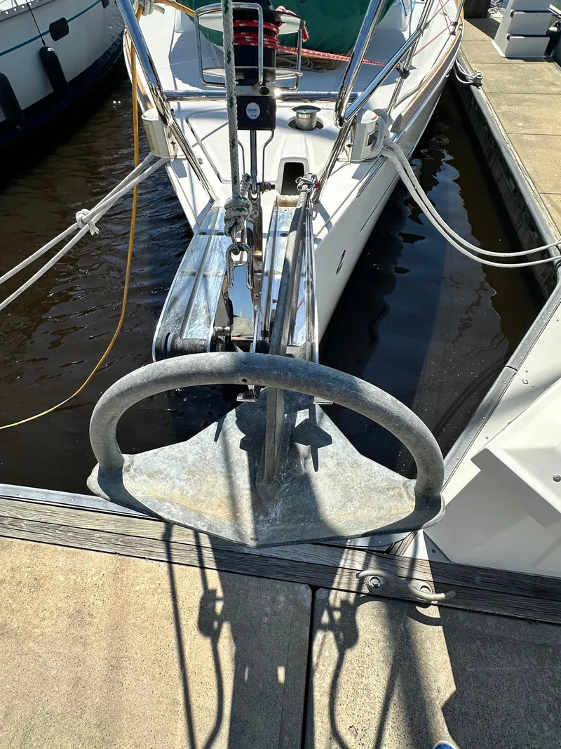 Slide: The Image of 2012 Beneteau Oceanis 41 sailboat docked, featuring anchor and bow details. - 5